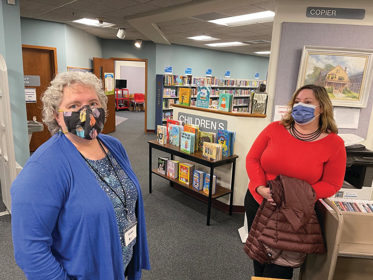GREETINGS FROM CENTRAL:Auburn Branch Librarian Karen McGrath, left, and Assistant Library Director Julie Holden chat during last week’s event at Auburn.